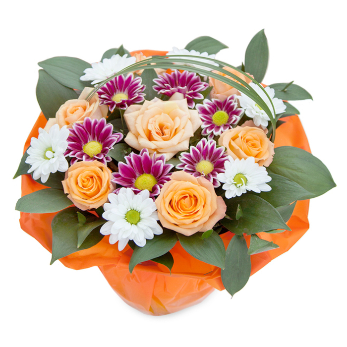 Embodying the peaceful yet vibrant spirit of Stanmore, this hand-tied bouquet is photographed from above against a bright white canvas, highlighting its colours and forms with striking clarity. Majestic roses, unfurling in shades of soft apricot and vivacious orange, take centre stage-their fullness and warmth echoing the gardens of Stanmore and the nearby open spaces of Bernays Gardens. Sweeping between them are white chrysanthemums with delicate, daisy-like petals and lively green centers, alongside clusters of ornate magenta and purple mums whose fine petals and vivid lime-green discs offer captivating contrast. Framing the blooms is a foundation of deep green, lustrous leaves, their ample presence reinforcing the sense of fullness and the nurturing quality often found in Stanmore's landscaped parks. Flowing gracefully above the bouquet, a curved flourish of green grass lends a modern, airy element that draws the eye and adds a whisper of playful sophistication. At the base, vibrant orange cellophane is gathered in artful, crinkled layers, reflecting the cheerful vibrancy of both the flowers and Stanmore's thriving community life. Every detail, from meticulous texture selection to harmonious colouring, speaks to the exceptional artistry and heartfelt care that defines flower arrangements prepared in Stanmore. Whether marking a momentous occasion or simply delivering joy to a neighbour or friend, this bouquet stands as a local symbol of celebration and gratitude.
