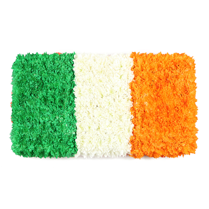 An elegant, hand-tied interpretation of the Irish Tricolour, this rectangular floral banner sits against a pristine white backdrop, its three vertical stripes created entirely from densely packed petals. The emerald left panel is a lush field of tiny green blooms-perhaps chrysanthemums or carnations-whose minute blossoms form a soft, veined texture that suggests a living carpet. The central stripe of white petals appears soft and airy, while the right-hand orange panel glows with warm sunshine, built from countless tiny blossoms that echo the texture of its neighbours. The entire banner preserves the flag's proportional rhythm, a mindful balance of colour and form that can be admired up close or from a distance.

The symbolism runs deep here: unity through difference, peace as a shared longing, and heritage carried in every petal. The white background elevates the colours, giving the piece an almost luminescent clarity-perfect for cultural features, St Patrick's Day features, or remembrance articles about Irish identity in Ireland and Britain alike. In Stanmore, this kind of crafted floral piece is cherished for events at the community hall, local churches, and spring markets nearby Canons Park. Flower Delivery Stanmore offers similar works with dependable, same-day delivery across Stanmore and surrounding NW London locales, bringing a handcrafted statement of pride and belonging into homes and gathering spaces.