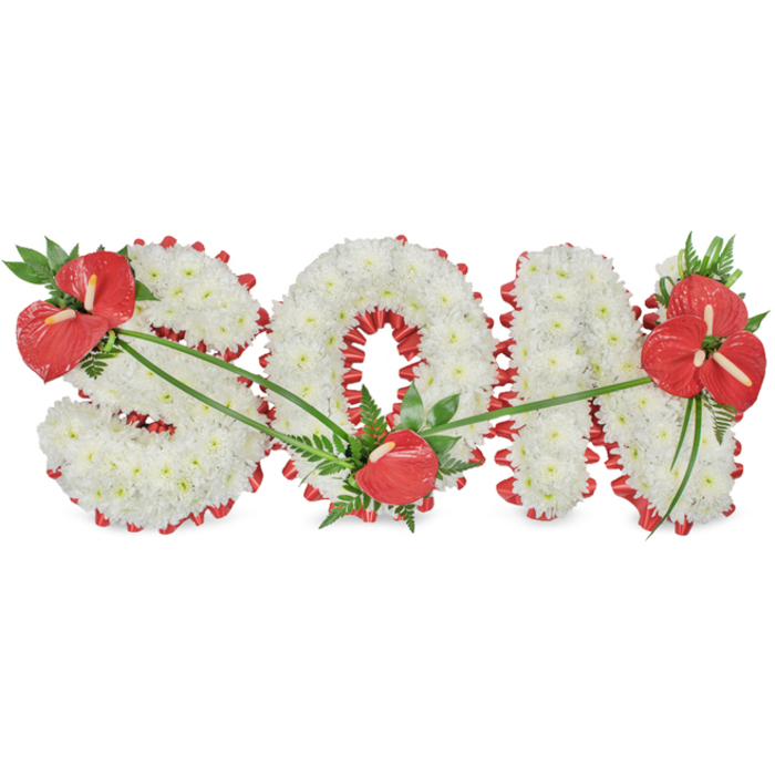 The photograph captures a meticulously designed sympathy tribute spelling the word SON in large, freestanding letters, displayed against a bright, white background so that no detail is lost. Each letter is thickly padded with white chrysanthemums, their small, clustered blooms giving a plush, cushiony appearance that suggests softness and peace. The petals form a uniform surface, with tiny shadows between them adding quiet depth. Around every edge runs a band of rich red satin ribbon, gently ruffled to create a scalloped border that outlines the silhouette of each letter. It follows the flowing curves of the S, wraps around the circular centre of the O, and crisply frames the vertical and diagonal strokes of the N, providing both structure and contrast. Three distinct groupings of red anthuriums, with their high-gloss, heart-shaped spathes and sturdy central spadices, add emotional emphasis. On the upper left of the S, a substantial cluster of anthuriums, surrounded by dark evergreen leaves and delicate fern fronds, forms the first focal point. At the bottom of the O, a single anthurium, supported by smaller foliage, rests lightly on the white flowers, offering a more intimate touch. Over on the right side of the N, a fuller spray containing several anthuriums and lush greenery brings visual balance to the composition. Thin, sweeping leaves and stems arc gracefully over the chrysanthemums, linking each red highlight and guiding the eye along the tribute. This style of arrangement, often requested in Stanmore for services held near Bentley Priory or along Marsh Lane, provides a tender way to express love, remembrance, and pride for a much-loved son.