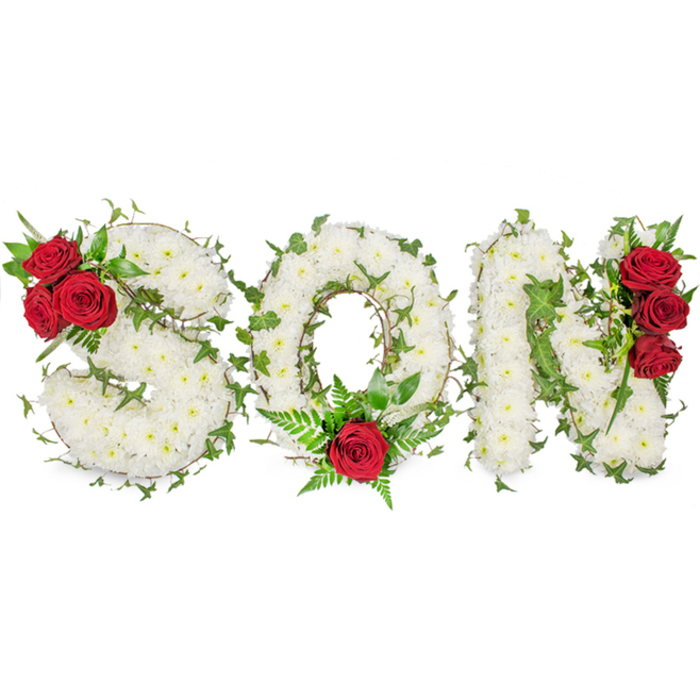 A solemn, lovingly crafted memorial arrangement spells the word SON in three bold, capital letters, each letter formed from a dense, carpet-like mass of small white spray chrysanthemums that appear almost silk-soft to the touch. The pristine whites are set against a clean white background and bathed in gentle, natural light that reveals the tiny, layered petals and the soft, almost green floral scent common to chrysanthemums. Interwoven throughout the white letters, vibrant green ivy and delicate fern fronds trace the shapes, lending a living, evergreen symbolism of remembrance and resilience. Strategic red accents create a quiet, powerful focal story: the S carries a tight cluster of three deep red roses at its upper left curve with accompanying glossy foliage, the O holds a single statement red rose at its lower centre cradled by feathery greenery, and the N is verticaly accented with three richly hued roses along its right side. The interplay of pure white, passionate red, and bright green yields a visual language of purity, enduring love, and heartfelt loss. As an experienced local florist, and on behalf of Flower Delivery Stanmore, I picture this tribute placed near Stanmore High Street or at a service close to Stanmore Common - a composed, personal expression of condolence meant to honour a son with dignity and tenderness.