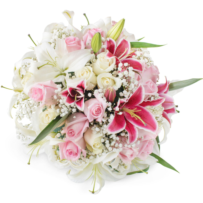 Presented against a bright, white backdrop, this exquisitely arranged round bouquet showcases the classic romance of lilies and roses, crafted with the kind of care you might expect from Flower Delivery Stanmore for a special family occasion. The design is full and domed, so that from above you see almost nothing but petals and tiny blooms. Large white lilies provide the main structure, their star-shaped trumpets opening wide, each petal thick and satin-smooth, curling slightly at the tips and revealing subtle green shading at the base. Interspersed among them, pastel pink roses and creamy, almost buttery, white roses bring softness and variety; some are just beginning to open, with tightly layered centres, while others are fully blossomed, their velvety petals forming generous cups that catch the light. Several bold fuchsia Oriental lilies, likely Stargazers, punctuate the design with bursts of colour, their rich magenta petals freckled with darker speckles and completed by striking yellow anthers. Delicate white baby's breath threads through the arrangement, its countless tiny flowers creating a cloud-like texture that softens the boundaries between the larger blooms. Green lily leaves and a few closed buds peek through at the edges, adding freshness and a natural frame. The bouquet is photographed under even, clear lighting, which highlights the contrast between the crisp whites, warm creams, gentle pinks, and vibrant fuchsias, with no harsh shadows to break the mood. This arrangement would sit beautifully on a dining table near Stanmore station for an anniversary dinner, in a living room off Belmont Circle to say thank you, or as an elegant, comforting tribute for more reflective occasions, always conveying grace, love, and thoughtful intention.