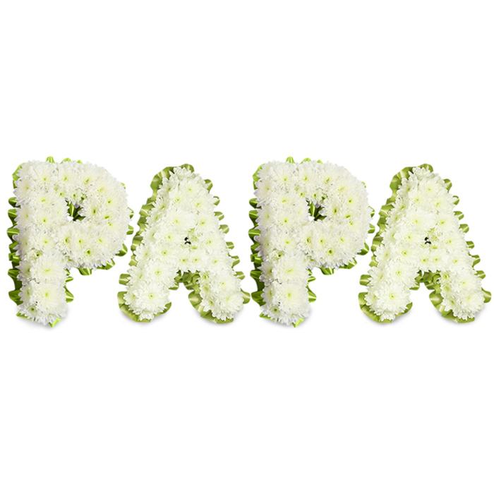 A beautifully restrained floral tribute that spells out PAPA in striking, uppercase letters laid across a stark white background, each letter handcrafted from compact clusters of small white flowers-likely spray chrysanthemums or similar soft, ruffled white blooms-giving every character a full, textured dome of petals. The edges are neatly trimmed and accented with a pale green ribbon or slender band of fresh foliage that folds and pleats along the contours, creating a subtle scalloped frame that defines each letter while bringing a cool vitality to the composition. The letters are arranged horizontally with even spacing and clean lines, producing a formal, composed piece frequently chosen for funeral processions, memorial displays, or intimate remembrance gatherings. There is a quiet sensory detail in the work: the mild, comforting scent of chrysanthemums, the gentle sheen on petals under soft overhead light, and the measured weight of skilled hands that set each bloom for symmetry and lasting presence. Locally, these tributes are often requested by families in Stanmore and nearby Canons Park for services at local chapels or for placement near family graves; the white-and-green colourway reads as calm, pure, and deeply respectful. The arrangement speaks of familial closeness and farewell, offering a visual and olfactory moment of reflection that honours a father's memory with simple dignity and expert floristry.