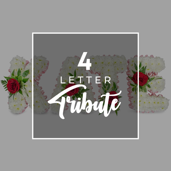 This carefully staged photograph showcases a custom four-letter funeral flower arrangement, the sort of tribute often chosen by families in Stanmore for heartfelt farewells. Dominating the centre is a square panel of deep grey, gently transparent so that the flowers beneath still cast faint shapes and colours. A slim white border encloses this square, giving it a framed, polished feel against the pale grey backdrop. Within the panel, bold white lettering spells out 4 LETTER in a simple, contemporary typeface, and beneath it, the word Tribute appears in an elegant, flowing script, adding a softer, more personal note as though written by hand. Peeking out from behind this overlay, you see four distinct floral letters forming a meaningful name such as KATE, their forms extending beyond the panel's left and right edges. Each individual letter is constructed from a dense layer of white chrysanthemums, their compact blooms overlapping so completely that no gaps are visible, producing a plush, cloud-like texture associated with traditional sympathy flowers. A fine edging of pale pink ribbon traces the outline of each letter, barely glimpsed but adding warmth and definition. Set among the white chrysanthemums, rich red roses rest in small clusters, accompanied by deep green foliage that curls and fans outward, adding contrast and a sense of living movement. The roses' velvety petals glow against the white, evoking love, respect, and tender remembrance, much like the floral names placed on coffins or beside memorials in Stanmore's peaceful burial grounds. The minimal background and clean typography ensure all attention remains on the idea of a four-letter floral tribute-simple in structure, yet deeply meaningful for families saying goodbye.