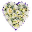 A tender, heart-shaped spray sits against a clean white backdrop, a quiet study in whites, creams and soft greens meant to comfort. At the center rests a single creamy white rose, its petals curling in a perfect spiral that catches a soft, almost morning-like light and draws the eye inward. Around that focal bloom, layers of ruffled white carnations offer gentle volume and a plush, tactile softness; their frilled edges form the rounded shoulders of the heart and invite a slow, reverent touch. Interspersed among the larger blooms are white spider chrysanthemums and small button-like daisies whose spidery petals and pale lime-green centres add a whisper of liveliness and fine texture. Scattered clusters of petite cream roses and budding lisianthus bring delicate points of interest, their tighter forms giving depth and the sense of moments held close.

Cool-toned sprigs of blue-green eucalyptus are tucked through the composition, their matte, coin-shaped leaves introducing muted contrast and a faint herbal scent that would lightly perfume a chapel or quiet home. The entire heart is edged with a deep lavender-to-rich purple ruffled ribbon, pleated into a scalloped frame that both defines the shape and lends a solemn, dignified accent. The careful placement of each bloom and leaf-densely layered yet airy where it needs to be-speaks to practiced hands and a mindful intention to convey enduring love, peace and respect. Imagined on a funeral easel or laid beside a casket, this arrangement reads as a gentle emblem of remembrance, suited to memorial services in Stanmore and the surrounding neighbourhoods, where families seek a composed, comforting floral tribute.