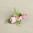 Delicately arranged on a light neutral linen, reminiscent of Stanmore's inviting local venues, this beautifully handcrafted boutonniere features a tightly coiled blush pink rose at its centre, emanating warmth and elegance with each soft spiral of petal. Beside it, a graceful peach-pink alstroemeria flower unfolds, highlighting accents of gold and distinctive, fine markings at its core. Sprays of dainty baby's breath and small, vivid green button mums peek between the larger flowers, infusing the piece with a touch of airy brightness, while the green backdrop-a combination of slender grass blades, wispy fern fronds, and deep green leaves-adds both structure and lively texture. A luxurious fuchsia pink satin ribbon is tied with precision into a sweet bow, cradling the base of the boutonniere and catching the light like a jewel at a celebration in Stanmore Place. Every petal and leaf is softly illuminated to accentuate natural colour and intricate form, evoking a sense of refined festivity. Meant for weddings, proms, or any elegant local event, this floral accent embodies the freshness, romance, and attentive craftsmanship renowned among Stanmore's florists, serving as a gentle symbol of love and joyful gathering.