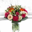 Brimming with vitality, this bouquet encapsulates the feeling of a joyful celebration-a perfect burst of colour and warmth lovingly crafted by a local Stanmore florist. Spirited orange gerberas shine with an energy that calls to mind the laughter and light found at community events in Stanmore Place, softened by blush pink roses and the rich, velvety texture of magenta carnations nestled together. Creamy ivory roses and gentle, peachy gerberas imbue the design with dignity and gentle affection, balancing the composition with an air of quiet elegance. Lush, glossy greens cradle the arrangement, providing a sense of abundance and natural structure reminiscent of tranquil walks through Stanmore's green spaces. Illuminated by bright natural light, each petal's delicate veins and vibrant hues come alive, making the bouquet appear almost radiant. Whether given as a gift to mark a milestone or to bring a spark of happiness to daily life in Stanmore, this bouquet melds harmony, expert skill, and heartfelt emotion-a beautiful expression of celebration and the local artistry that brightens neighbourhoods one bloom at a time.