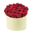 From the leafy streets of Stanmore, this luxurious rose presentation exudes romance and thoughtful gifting. The centerpiece is a lush gathering of deep red roses-approximately two dozen or more-each bloom velvety to the touch, with petals tightly furled as if in prime, newly opened moments. They are artfully arranged to fill a round, pale cream-colored box with a sleek, matte finish, a container whose shape recalls a classic hat-box destined for premium flower delivery. The bouquet forms a dense dome that rises just above the rim, a confident splash of colour that feels both intimate and grand.

Between the crimson heads, subtle bursts of dark green foliage peek through, adding natural contrast and a breath of freshness to the arrangement. The composition is captured from a slightly elevated, three-quarter angle, centering the elegant blossoms and their chic packaging against a clean white background that keeps the focus where it belongs. The light softens the petals, enhancing their velour-like texture and the box's smooth surface, creating a sense of luxury that invites touch and memory. This is a gift that speaks of love, devotion, and romance, perfectly suited to anniversaries, Valentine's gestures, or a refined surprise for a special someone. It represents a thoughtful expression you'd mail across Stanmore with same-day delivery options, bringing a couture bouquet to doors in Canons Park, Belmont, and surrounding NW London streets. Flower Delivery Stanmore is proud to present such a statement piece, crafted with care and designed to resonate with meaningful moments.
