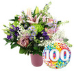 Set against a pure white backdrop, this elegant 100th celebration bouquet and balloon pairing looks as if it is ready to be delivered across Stanmore for a very special birthday. The flowers are gathered into a stylish ribbed vase finished in a soft, matte pink, lending a gentle, feminine base to the design. From it, a lush, rounded arrangement of flowers rises, rich with texture and harmonious colour. Pale pink Oriental lilies stand prominently near the top, some fully open and star-shaped with slightly recurved petals and prominent stamens, others still in elongated buds that signal more beauty to come. Tucked around them are luxurious roses in shades of blush and dusty rose, their velvety petals curling outward in layered spirals. Deep purple lisianthus provide a rich, contrasting accent, while delicate lavender asters with sunny yellow centres dot the design with a wildflower charm, reminiscent of the gentle greenery around Stanmore's quiet residential streets. Bright lime green button chrysanthemums punctuate the bouquet, adding lively colour and a tactile, rounded texture. Fine, airy clusters of white baby's breath soften the spaces between blooms, creating a light, cloud-like veil. Lush dark green foliage spreads outwards, framing the composition and enhancing the pastel tones. To the lower right of the bouquet, just overlapping its base, a round foil balloon gleams. Its metallic surface is decorated with a joyful pattern of tiny confetti dots in red, orange, yellow, green, blue, and purple. At the centre, the large white numerals 100 stand out clearly, with a subtle drop shadow to give a sense of depth. Together, the abundant flowers and jubilant balloon convey the warmth, gratitude, and excitement of reaching a hundred-year milestone in the Stanmore area, whether for a birthday, an anniversary, or another remarkable centenary event.
