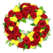 In this photograph, a substantial circular wreath designed for a funeral or memorial is showcased against a smooth white background, highlighting the richness of its red and yellow palette. The wreath forms a complete, even ring with an open centre, filled edge to edge with flowers so that it appears plush and full. Deep red roses dominate, their velvety petals arranged in layered spirals, opening from tight, almost conical centres into broad, cupped blooms. The reds shift subtly between bright, passionate crimson and darker, more contemplative burgundy, giving the wreath emotional depth. Interlaced among the roses, clusters of small yellow chrysanthemums provide a bright counterpoint. These blooms, composed of numerous fine petals that radiate outward, form rounded, cushiony shapes that introduce softness and light. Nestled around and beneath the roses and chrysanthemums, a selection of greenery ties the design together: broad, glossy leaves in a rich green hue echo the wreath's circular outline, while sprigs of softer, muted grey-green foliage break up the colour and add an organic, natural feel. The lighting is evenly distributed, bathing the flowers in a gentle brightness that emphasises their freshness and careful placement, as if arranged only moments earlier by a Stanmore florist from Flower Delivery Stanmore in a studio near Stanmore Hill or close to Queensbury. This wreath appears perfectly suited to a chapel service, crematorium farewell, or graveside tribute, offering a visually striking expression of love, respect, and remembrance for a life deeply cherished.