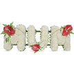 A dignified three-dimensional tribute spells the word MUM in bold capital letters against a clean white backdrop, each letter built from hundreds of small, pristine white spray chrysanthemums. The surface reads like a soft, cloud-like cushion - tightly clustered blooms that create a seamless, tranquil field of ivory; up close you can almost sense the gentle scent of chrysanthemum and the papery texture of each petal. A subtle dark green framework gives the letters their crisp edges, peeking through only where the chrysanthemums are trimmed, which reinforces a sense of quiet structure beneath the softness. Three glossy red anthuriums punctuate the composition: one set prominently on the upper left curve of the first M, another nestling in the lower curve of the U, and the third gracing the upper right curve of the final M. Their waxy, heart-shaped spathes and yellow-white spadices catch the light, offering a warm, loving contrast to the solemn white. Clusters of deep green foliage - feathery fern fronds and broader leaves - cradle each anthurium, while thin, arching blades of grass or stems sweep gently across the letters, visually linking the three red focal points and guiding the eye in a flowing line. Bathed in soft daylight, the arrangement reads as both a personal memorial and a carefully considered piece of funeral floristry, conveying reverence, enduring affection, and quiet comfort for a mother's service. It is the kind of arrangement families in Stanmore might choose for a wake or graveside tribute when they want to blend tradition, clarity of message, and gentle, heartfelt craftsmanship.