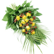 In this photograph, a long, elegant funeral spray of yellow roses and red berries lies against a brilliant white background, as if ready to be placed on a coffin in a Stanmore chapel or crematorium. The arrangement has a distinct diagonal flow, beginning with a more compact, structured section at the upper left. Here, the stems are tightly bound and hidden beneath an array of dark, glossy leaves, some of which are folded in clean, curved lines to create a professional, tailored finish that local florists at Flower Delivery Stanmore are known for. From this base, the spray extends gradually toward the lower right, gently tapering to a softer point. Running through the heart of the piece is a central band of yellow roses, roughly fifteen to twenty blooms in total. Their petals range from gently opening to generously unfurled, forming soft, layered spirals that glow in shades of butter and gold. Nestled amongst the roses are bright clusters of small, round red berries, most likely Hypericum, whose sheen and tight formation contrast beautifully with the open, velvety petals. Surrounding this interplay of flowers and berries is a rich framework of greenery in various textures: some leaves are broad and supportive, giving the design depth and volume, while others are finer and more feathery. Most eye-catching are the long, palm-like fronds that sweep out from the lower right, their slender leaflets creating a sense of movement and adding an almost serene, tropical grace. Altogether, the spray conveys comfort, respect, and understated beauty, making it a fitting floral tribute for funerals and remembrance gatherings across Stanmore, from local churches to services near Stanmore Country Park.